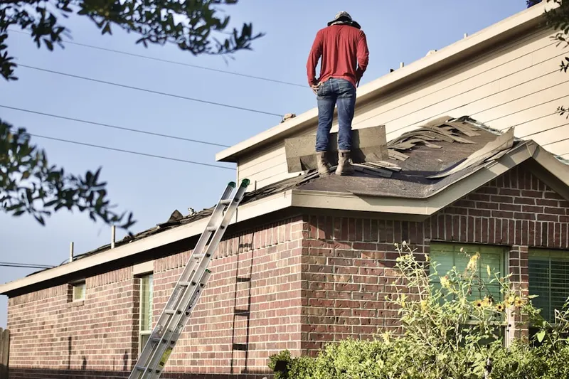 Professional roofer working on a residential roof in Marlboro Heights
